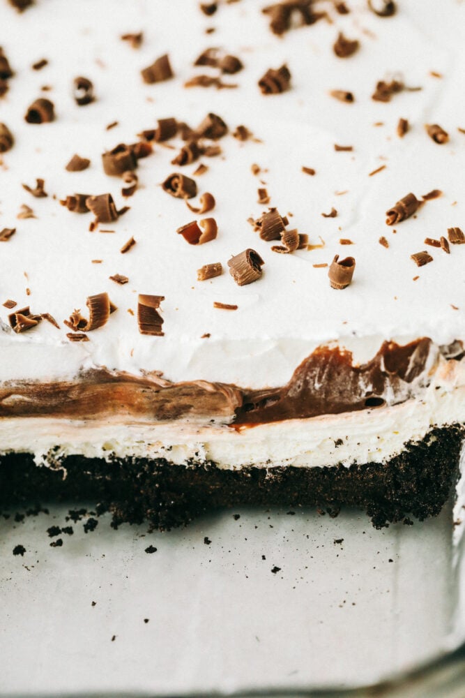 Oreo Lasagna is a no-bake slice of chocolate heaven! Layered with a cream cheese and pudding layer, sandwiched between whipped topping and luscious Oreo crust, it's too die for! Cross cut of the Oreo lasagna showing off the different layers.