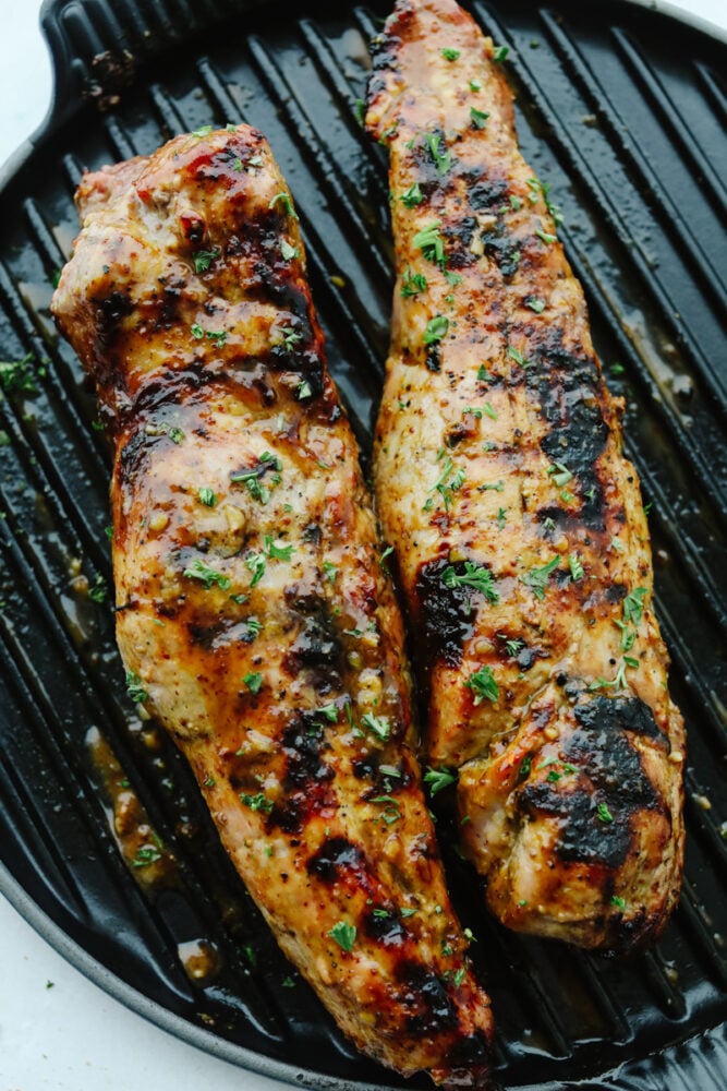 Grilled Honey Dijon Garlic Pork Tenderloin is juicy, tangy, flavorful and cooks up quickly and easily. With a dish this healthy and delicious, you will love having it in your weekly dinner lineup! Honey Dijon Garlic Pork Tenderloin on grill.