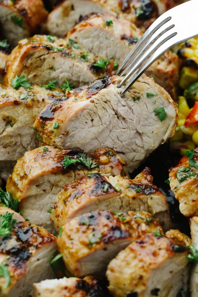 Grilled Honey Dijon Garlic Pork Tenderloin is juicy, tangy, flavorful and cooks up quickly and easily. With a dish this healthy and delicious, you will love having it in your weekly dinner lineup! Grilled Honey Dijon Garlic Pork Tenderloin, sliced.