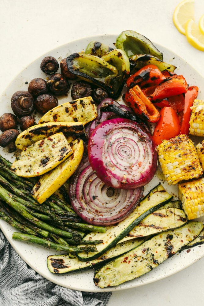 These delicious Grilled Vegetables are the perfect side to enhance any meal. They are drizzled with a savory garlic marinade that amplifies each vegetable's amazing flavor and texture! Variety of grilled vegetables on serving dish.