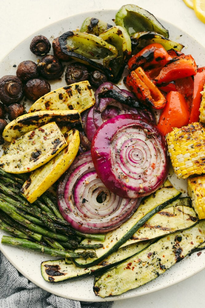 These delicious Grilled Vegetables are the perfect side to enhance any meal. They are drizzled with a savory garlic marinade that amplifies each vegetable's amazing flavor and texture! Variety of grilled vegetables on serving dish.