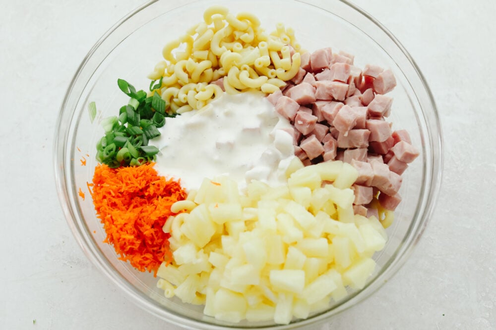 Hawaiian Macaroni Salad is the perfect side dish! It is a delicious macaroni pasta salad with ham, pineapple, shredded carrots, and green onions, and a tangy dressing. Ingredients for the Hawaiian Macaroni Salad