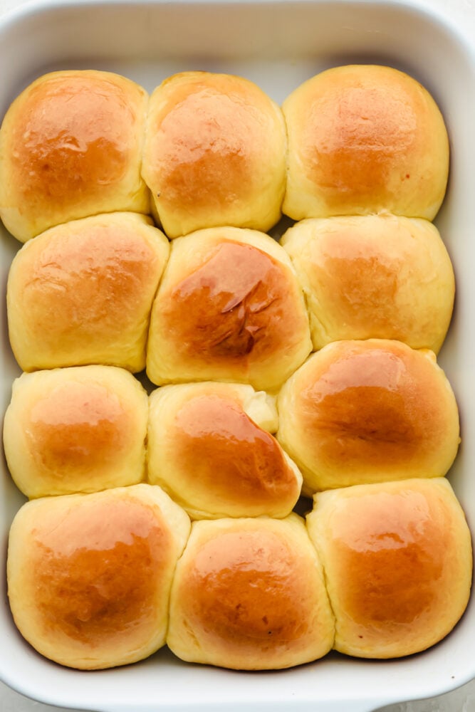 Moist, fluffy Hawaiian Sweet Rolls are a staple you will want to use for all your weekday meals. Whether you use them for sliders, sides, or just eat them as-is like me, they will be gone in no time with how sweet and buttery-soft they are! 12 baked rolls in pan.