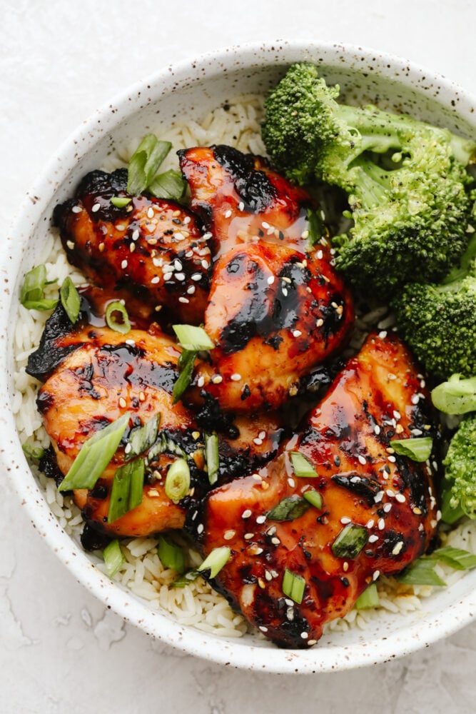 This Grilled Honey Garlic Chicken is healthy and delicious with a sweet, sticky garlic glaze. It only takes 5 ingredients to make the marinade and cooks up in less than 10 minutes. Honey Garlic Chicken in rice bowl with broccoli.
