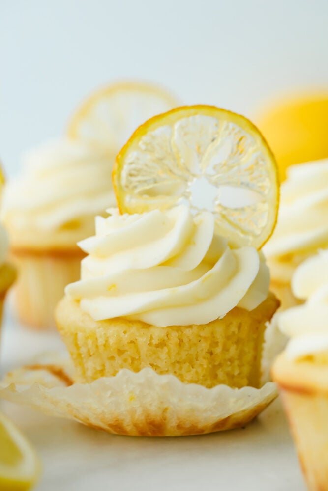 The AMAZING sweet and zesty flavors of these Lemon Cupcakes will have you hooked! Fresh lemon adds a pinch of summer to a classic, decadent treat. Lemon cupcake with lemon garnish