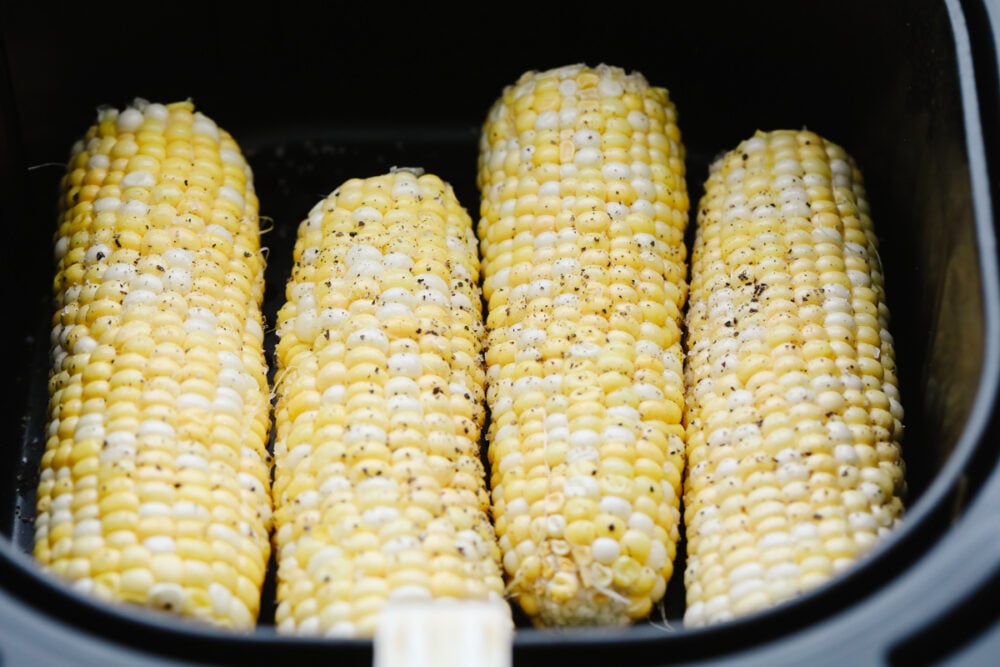 Air Fryer Corn on the Cob is going to change the way you cook corn. Super fast, tender, and full of flavor air fryer corn is insanely delicious. Corn on the cob in the air fryer with salt and pepper.