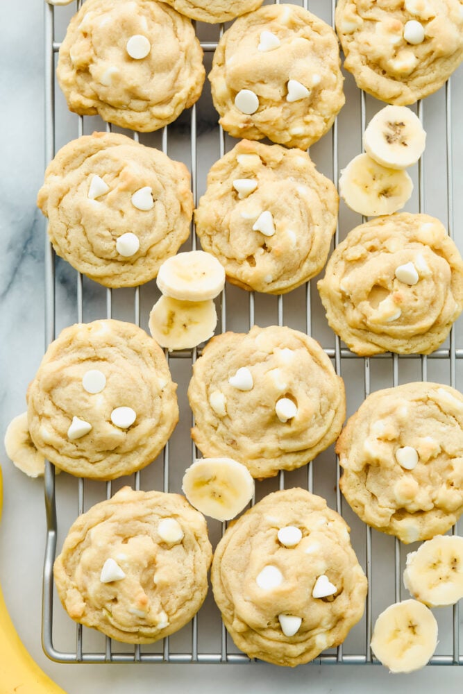 Banana Pudding Cookies are soft, chewy, and absolutely scrumptious. With all the banana flavor of a banana cream pie wrapped in a cookie. Banana pudding cookies on a wire rack.