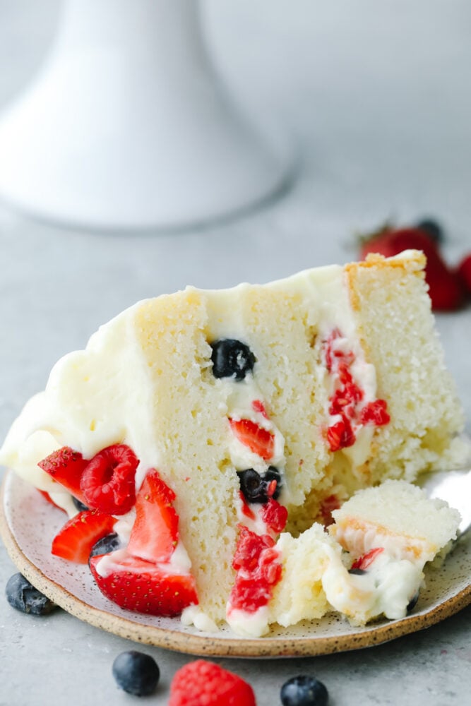 Showcase fresh summer berries with a supremely moist sponge cake and fluffy Chantilly cream! This beautiful Chantilly Berry Cake is a light, airy treat that is bound to impress! Close up of a slice of Chantilly Berry Cake.