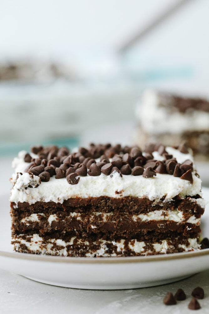 Chocolate Icebox Cake is an easy, and decadent chocolate lover's dream dessert. Made from simple ingredients and a bit of time, this no-bake cake is going to be a huge summertime hit! A slice of Chocolate Icebox cake on a plate.