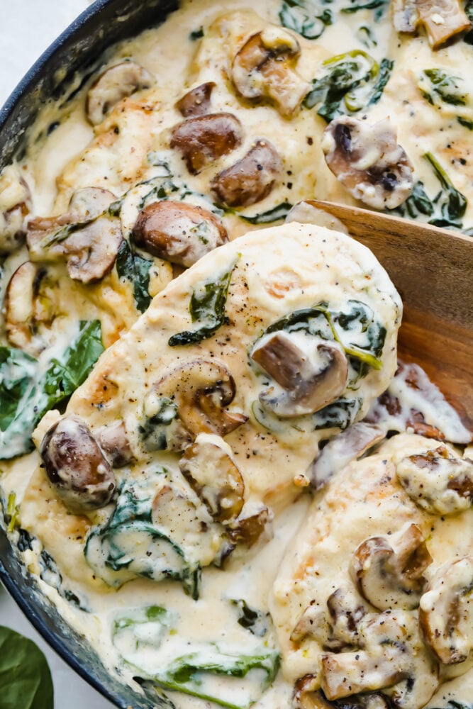 Creamy Parmesan Garlic Mushroom Chicken is ready in just 30 minutes and the parmesan garlic sauce will wow the entire family! This will become a new favorite! Creamy Parmesan Garlic Mushroom Chicken being cooked in a skillet.
