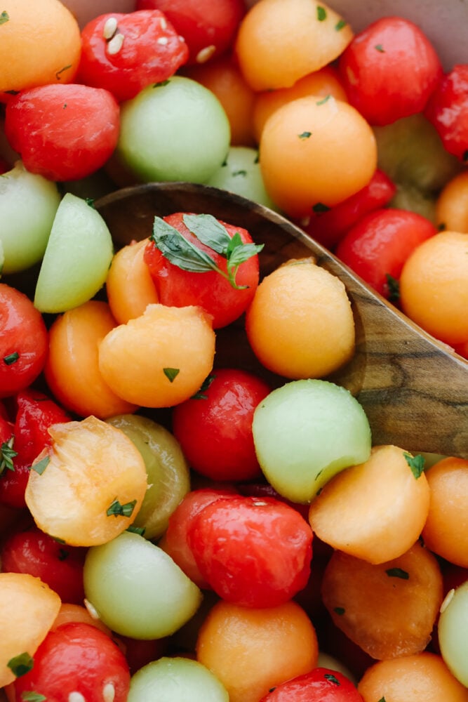 I don't know about you but nothing hits the spot more on a hot summer day than fresh fruit and salads! Combine the two together and our melon salad will leave you feeling refreshed and satisfied! 3 different melons on a spoon topped with mint dressing.