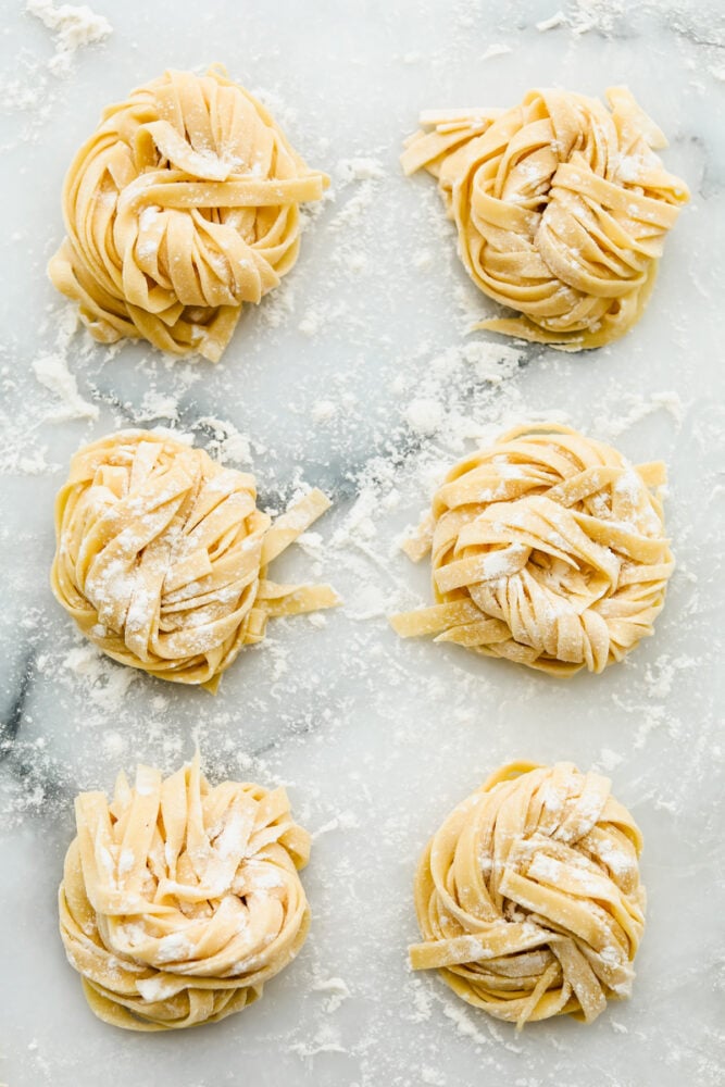 Homemade pasta is a labor of love but it is totally worth the extra work. This pasta is simple and easy, it just takes a bit of time Long strands of noodles in nests ready to cook.