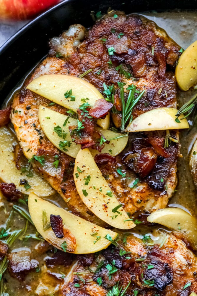 Pork Chops with an Apple Bacon Sauce are the answer to what's for dinner! Savory pork is smothered in a sweet and salty sauce that is going to wow your taste buds! A pork chop with apples in a bacon sauce.