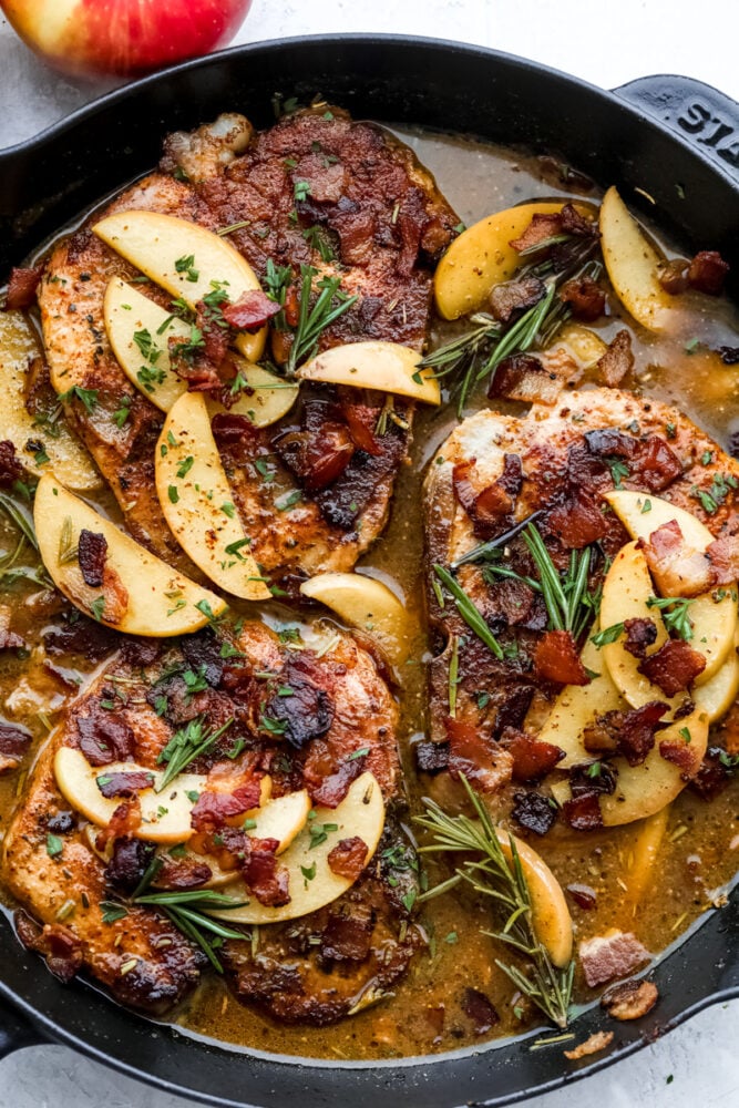 Pork Chops with an Apple Bacon Sauce are the answer to what's for dinner! Savory pork is smothered in a sweet and salty sauce that is going to wow your tastebuds! Pork chops with apples and bacon in a spicy sauce.