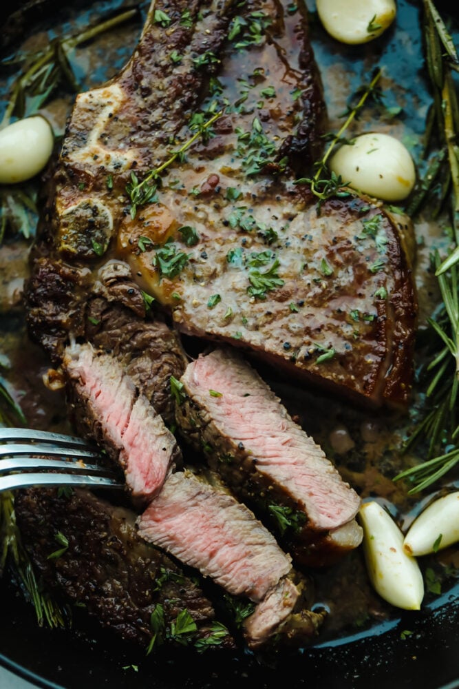Achieving steakhouse-worthy flavors doesnโt have to be difficult! The ultimate ribeye steak is juicy, flavorful, and seared to perfection all in the comfort of your kitchen. Cutting off slices of steak.