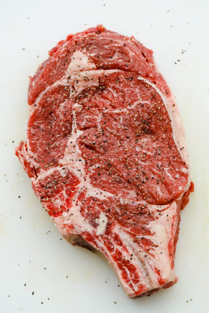 Achieving steakhouse-worthy flavors doesnโt have to be difficult! The ultimate ribeye steak is juicy, flavorful, and seared to perfection all in the comfort of your kitchen. A raw ribeye steak salted and peppered.