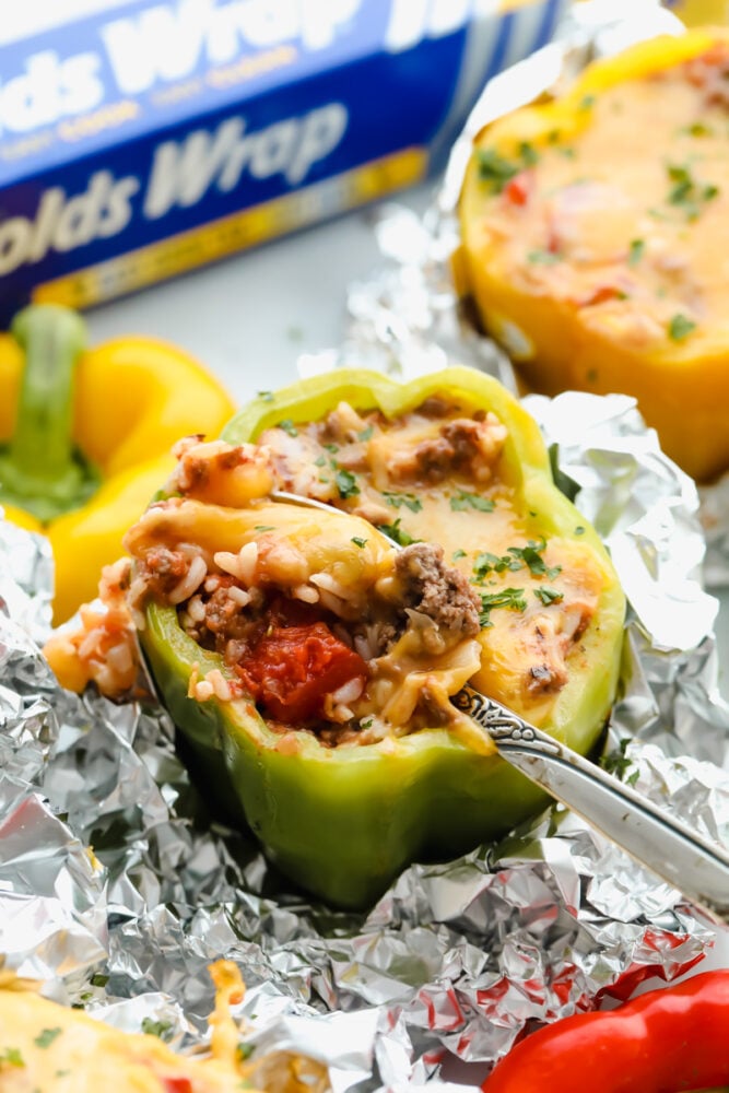 Stuffed bell peppers are filled with lean ground beef, rice, tomatoes, and the perfect blend of seasonings all topped with shredded cheese. Individually wrapped peppers make a colorful and delicious dinner with a beef combination full of flavor.