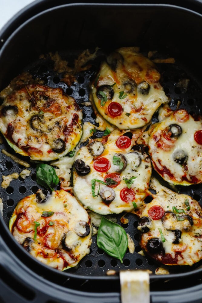 Air Fryer Zucchini Pizza Bites are the perfect low-carb way to eat your pizza and love it too! Quick and easy these make a perfect snack, appetizer, or light meal any time of the week! Zucchini pizza bites cooked in the air fryer.