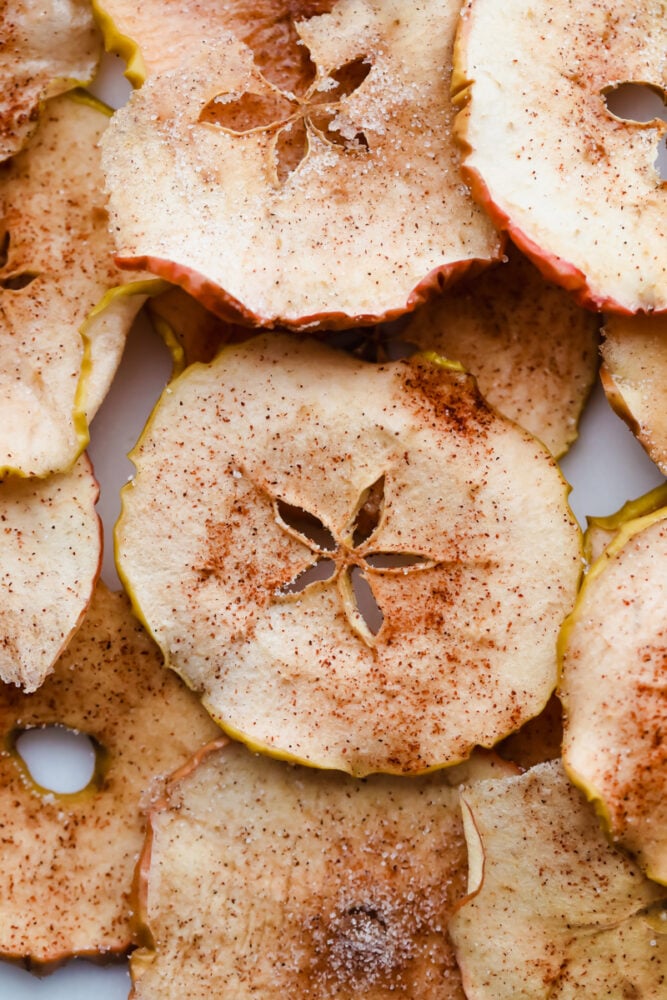 Baked Cinnamon Sugar Apple Chips is a healthy crunchy snack that is going to impress! Crunchy, crispy, sweet, and a bit spicy, these are going to change snack time Thinly sliced apples baked to a crisp with cinnamon and sugar.