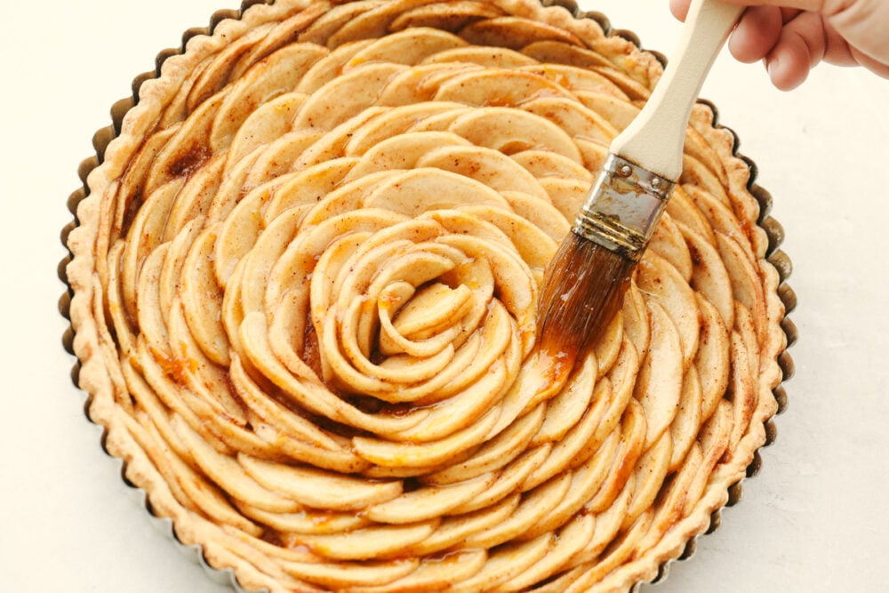Loaded with fresh apples and baked to a perfect golden brown, this beautiful apple tart is the pastry of the summer! A combination of buttery, nutty, and tart, it tastes as good as it looks! Brushing the top of the pastry with apricot preserves.