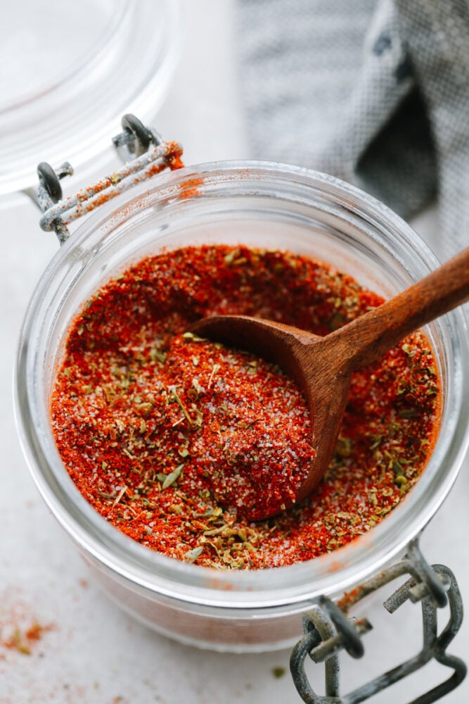 Blackened seasoning is all the spice without too much heat! This seasoning has a delicious, mouthwatering, Cajun taste that will take your food to the next level! Blackened seasoning with a spoon.