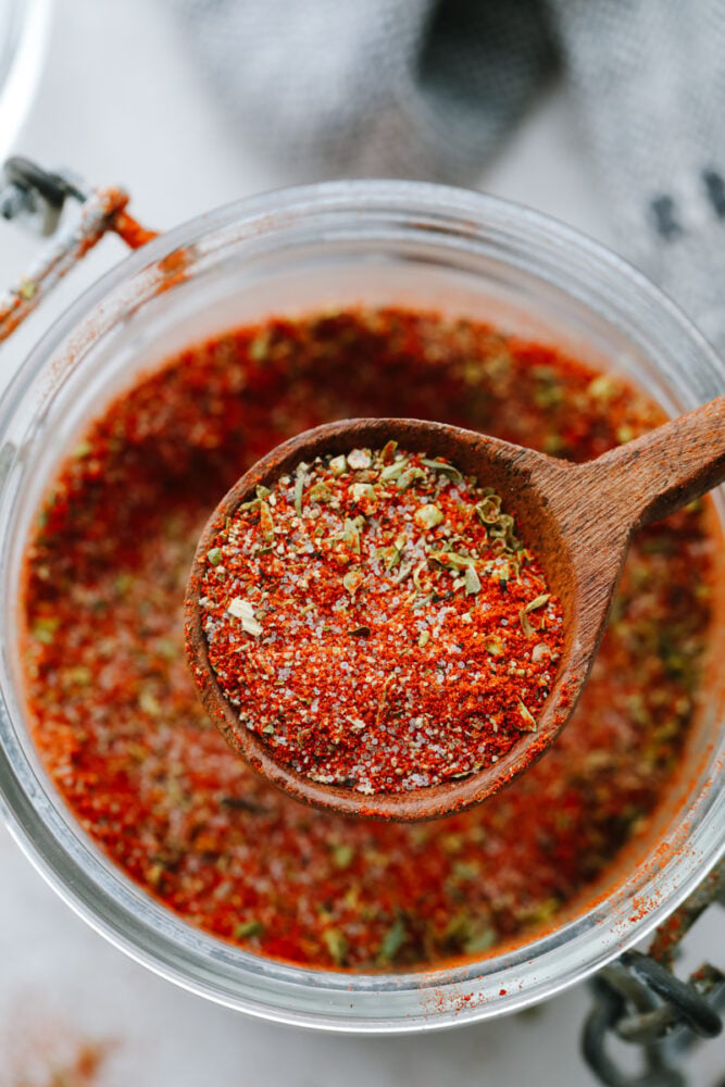 Blackened seasoning is all the spice without too much heat! This seasoning has a delicious, mouthwatering, Cajun taste that will take your food to the next level! Close up of blackened seasoning with a wooden spoon.