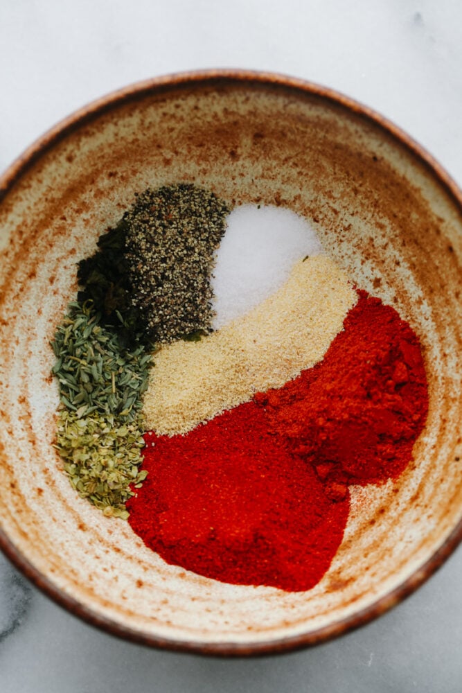 Blackened seasoning is all the spice without too much heat! This seasoning has a delicious, mouthwatering, Cajun taste that will take your food to the next level! Spices ready to be mixed in a bowl.