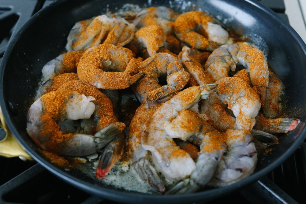 Cajun shrimp that is insanely delicious and only takes 5 minutes to make is the kind of dinner that dreams are made of! This recipe will knock your socks off and it will be something that the whole family will go crazy over! Uncooked shrimp sprinkled with seasoning.