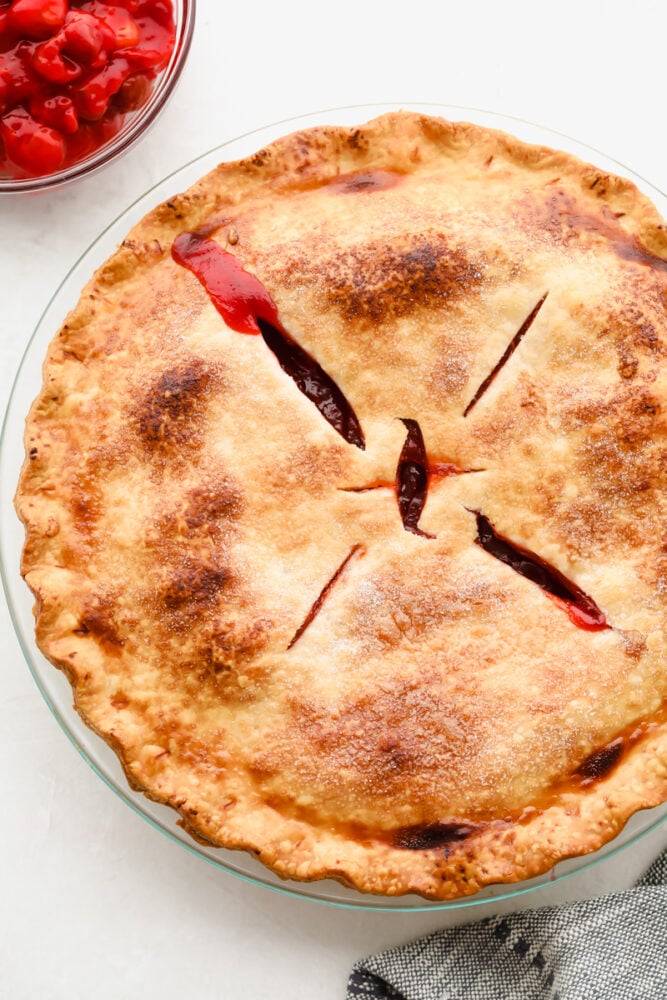 Homemade cherry pie is about as classic as they come and this recipe is no exception! Absolutely delicious, this mouthwatering pie has a tart filling and flaky crust that is so tasty that you won't be able to stop at just one slice! A beautiful golden brown finished pie.