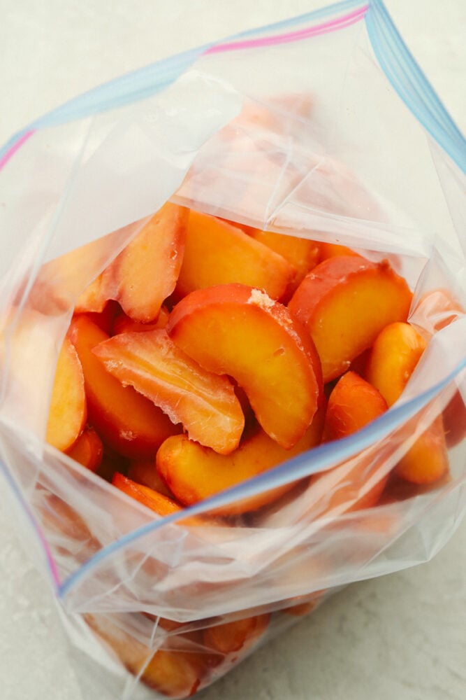 Freezing peaches is the best because they can be used in EVERYTHING! If you want to enjoy delicious peaches all year round then look no further because, with this recipe, you can have juicy, delicious peaches whenever you want! Frozen, sliced peaches in a ziplock bag.