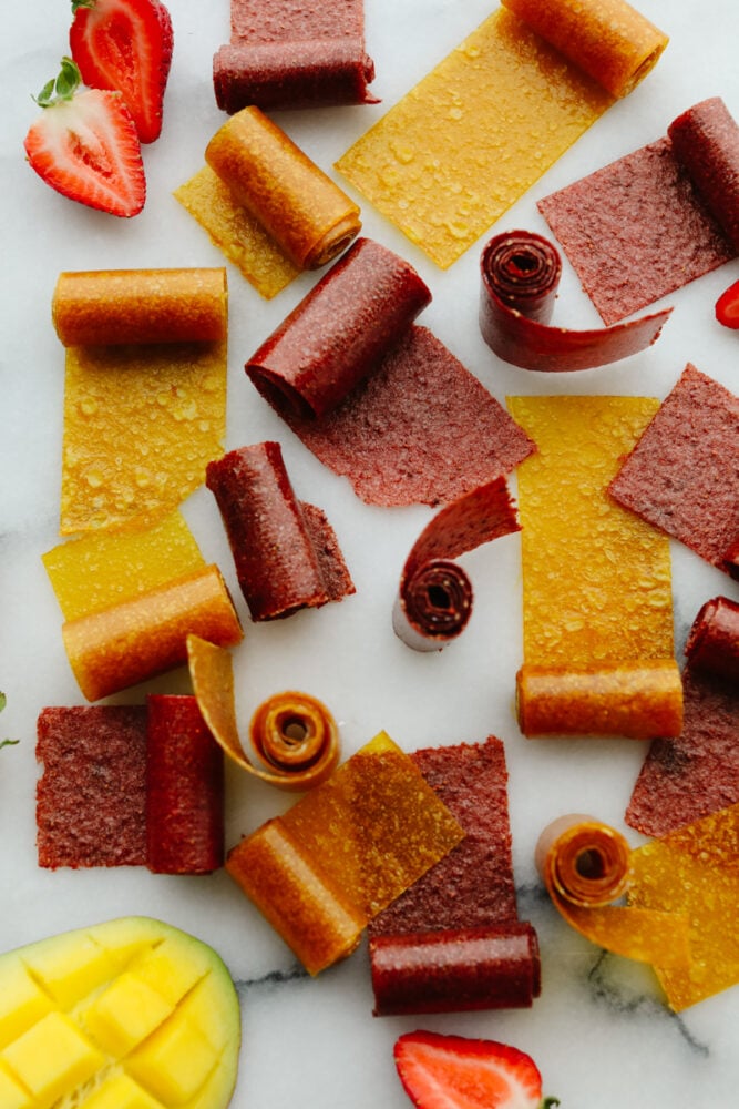 Homemade fruit leather is a fun, tasty way to turn ripe summer fruit into a snack that lasts all year! Just a few simple ingredients, no special tools, and a quick prep, then let the oven do the rest. Fruit leather that is all cooked.