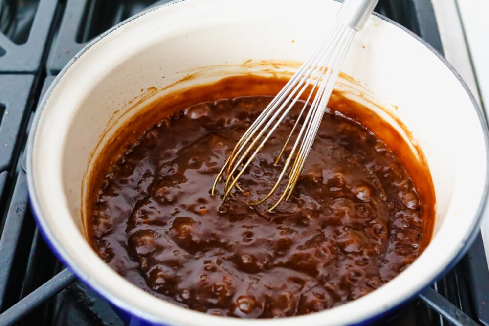 Rich, sweet, and salty, hoisin sauce is the perfect foundation for all of your Asian-inspired dishes. This homemade variation packs so much delicious flavor, you won't want store-bought again! Whisking sauce ingredients together on the stove.