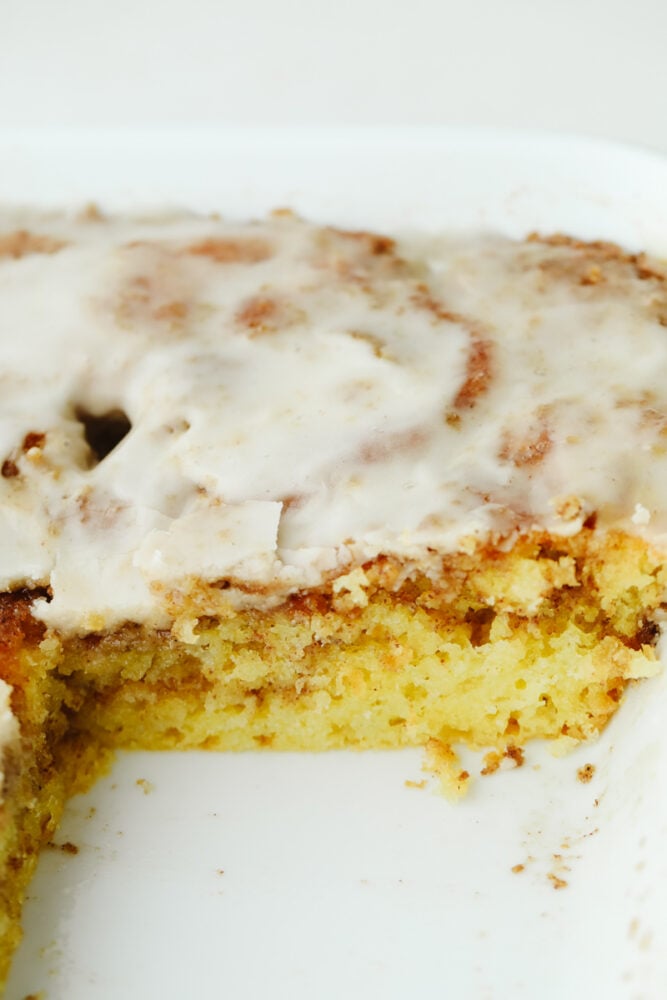 Honeybun cake is a super moist cake swirled with cinnamon and sugar and covered in a delicious vanilla glaze. Absolutely mouthwatering, this tried and true recipe tastes like a cinnamon roll but in cake form! Cake in a pan.