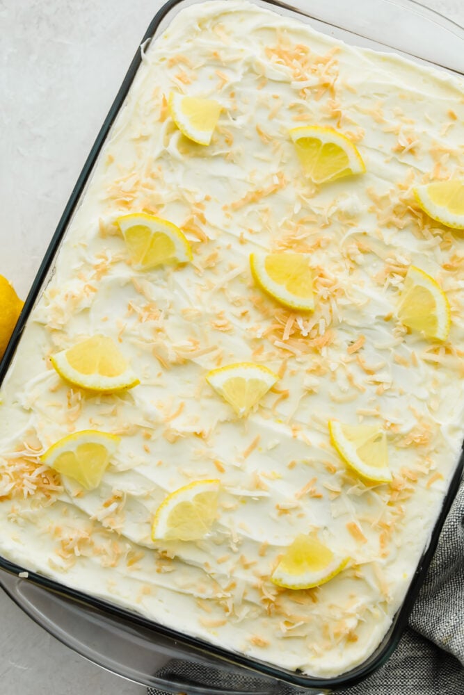 Lemon coconut cake is the perfect combination of delicious flavors and a soft texture! Moist and topped with the flaked coconut, this cake is insanely delicious and SOO good! An entire pan of lemon coconut cake.