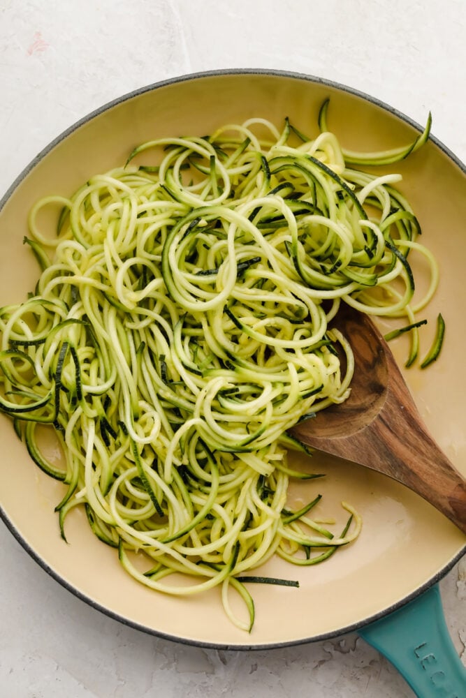 Zucchini noodles are the perfect low-carb option for pasta night. Use these 3 cooking methods to add a little healthy goodness to dinnertime! Zucchini noodles in a white skillet.