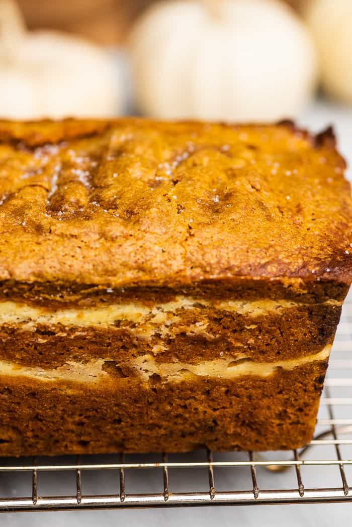 This cream cheese pumpkin bread recipe is truly the best ever. The moist and tender pumpkin bread is swirled with cream cheese frosting that's baked right into the loaf. It makes the perfect fall treat! Side view of layers in this cream cheese pumpkin bread.