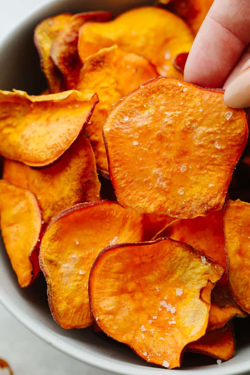 The air fryer is one of the most versatile appliances in today's kitchen! Learn how to use an air fryer to cook, reheat, and achieve that "fried" texture without frying in oil. Once you cook in the air fryer you will never look back! Sixth photo of sweet potato chips made in the air fryer.