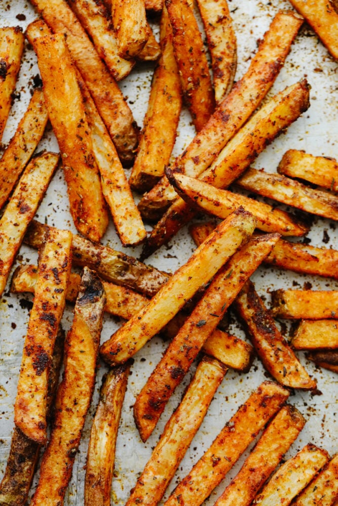 Cajun fries are baked to absolute perfection! With a delicious, spicy taste and crispy texture, I don't think that they get much better than this! Cajun fries cooked on a baking sheet.
