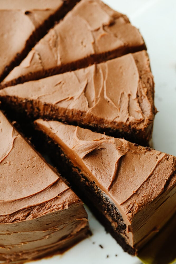 Chocolate cake is a classic, must-have recipe for every occasion! It is moist and delectable and the chocolate flavor is absolutely incredible! A whole chocolate cake that has been sliced.