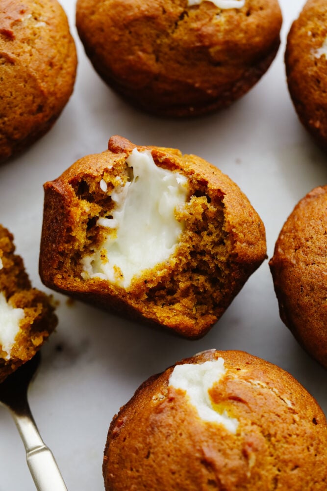 These pumpkin cream cheese muffins are the perfect combination of moist and savory on the outside and sweet and tangy on the inside! Pumpkin season is officially underway and these muffins are here for it! Pumpkin cream cheese muffins cut in half.