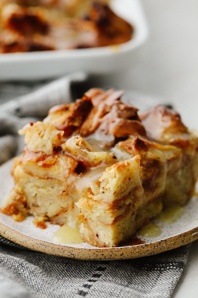 Croissant bread pudding is the perfect breakfast food! Drizzled with a creamy, vanilla sauce, this soft bread pudding is so amazing that you won't want to stop at just one piece! A slice of croissant bread pudding.