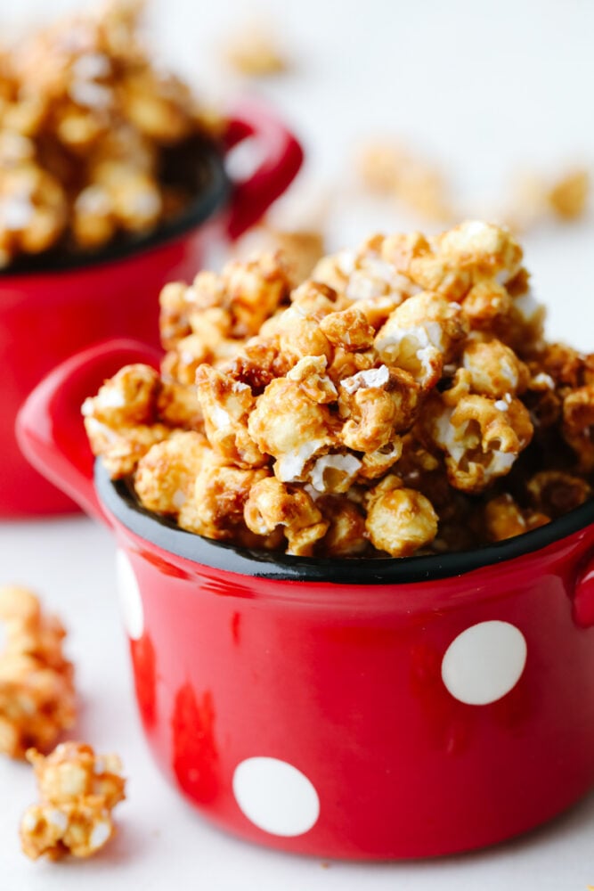 Crunchy caramel corn is absolutely divine! This classic crunchy snack delivers on that deep, rich caramel flavor that we all know and love! Eat it at home or on the go...Either way, you're going to be hooked! Crunchy caramel corn in a bowl.