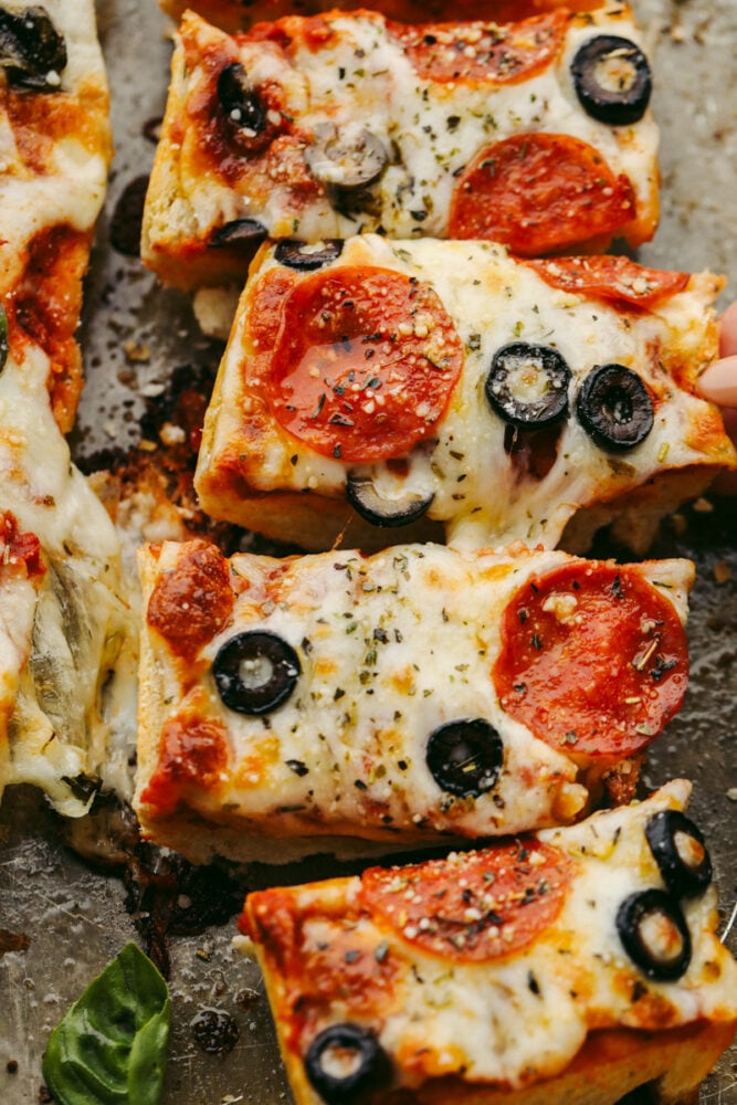 French bread pizza is quick, easy, AND delicious! Topped with all of your favorite things, this simple pizza delivers amazing taste! It's definitely a winner! Slices of French bread pizza.