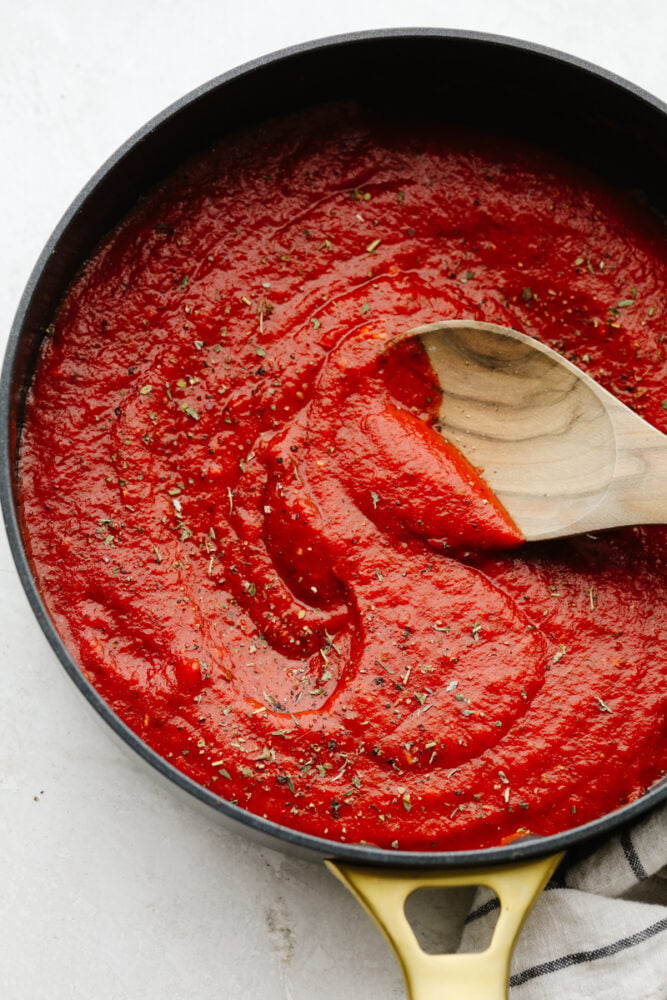 Using homemade pizza sauce is the perfect way to level up your pizzas! It's loaded with sautรฉed garlic, fresh herbs, and only takes 5 minutes to make! Finished pizza sauce in a saucepan.