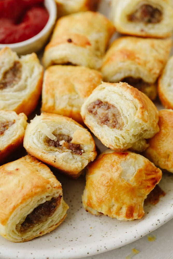 Sausage rolls are perfectly flaky, savory, and absolutely delicious! The best appetizer or snack, these sausage rolls will for sure be a hit among your party guests! Zoomed in picture of sausage rolls.