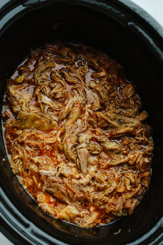 Perfectly sweet and tender, pulled pork is the absolute best when it comes to meat for your meal! This tried and true recipe is definitely one for the books! Sweet pulled pork being cooked in a slow cooker.