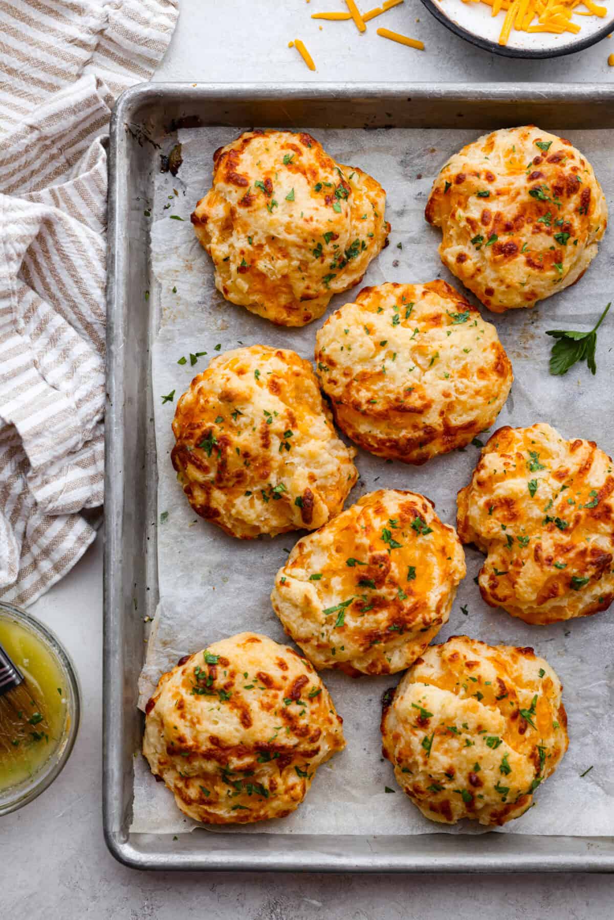 https://www.target.com/p/4pc-measuring-cup-set-vintage-silver-finish-hearth-38-hand-8482-with-magnolia/-/A-86250181#lnk=sametab Top view of red lobster cheddar bay biscuits on a baking sheet.