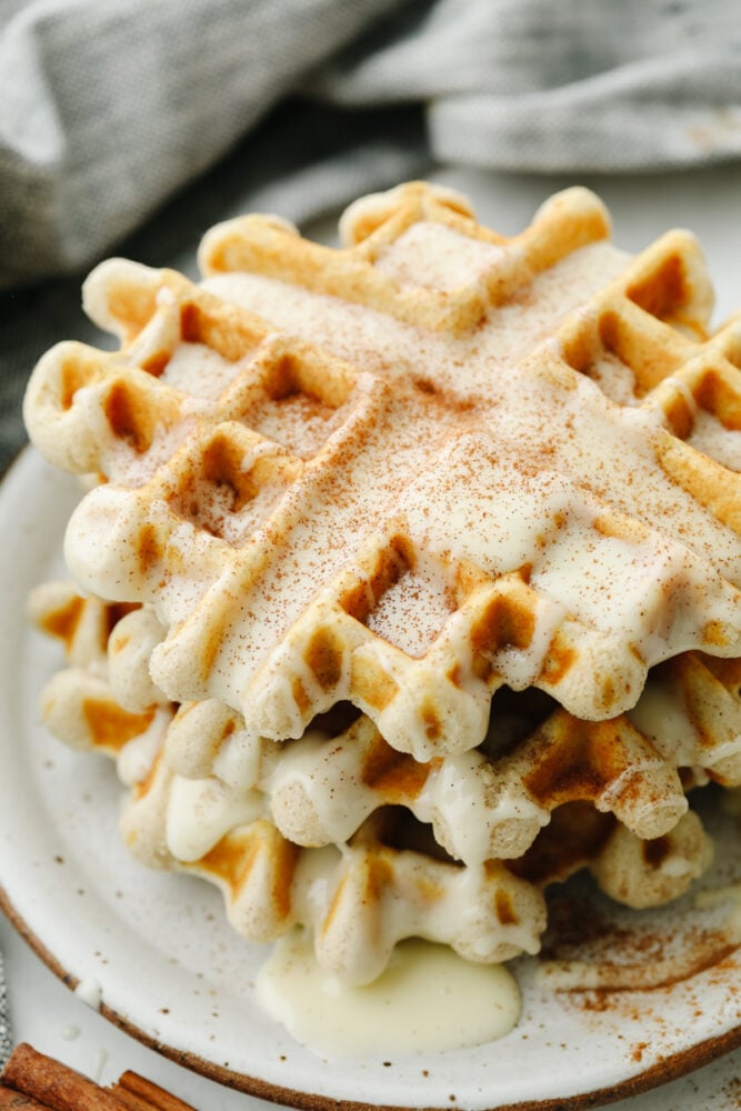 You just can't beat a delicious cinnamon waffle that is drizzled with a cream cheese glaze! It tastes just like a cinnamon roll in waffle form! A cinnamon roll waffle with a cream cheese glaze.