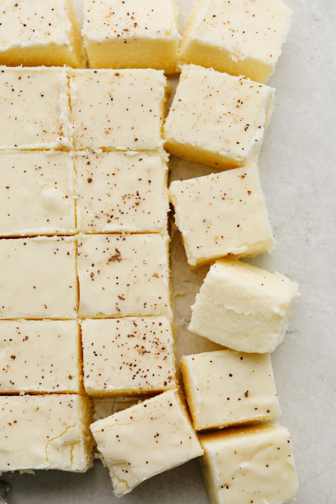 This eggnog fudge is every eggnog lover's dream! Each bite is filled with melt-in-your-mouth white chocolate and dusted with nutmeg! Cut squares of fudge.