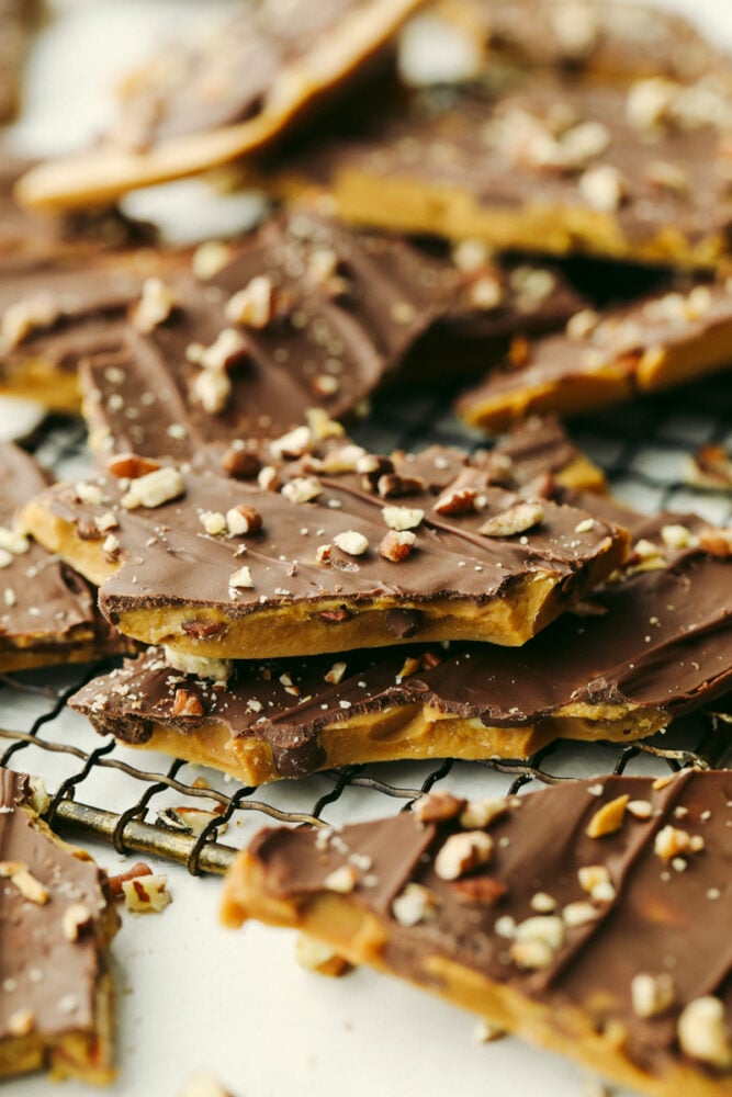 Homemade toffee is super simple with no candy thermometer required! This buttery chocolate treat is a must-make recipe this holiday season! Closeup of broken toffee pieces.